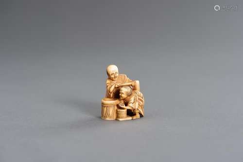 HOMIN: AN IVORY NETSUKE OF A COUPLE PREPARING MISO