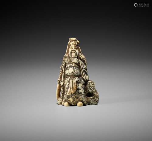 AN IVORY NETSUKE OF KAN’U LEANING AGAINST A ROCK