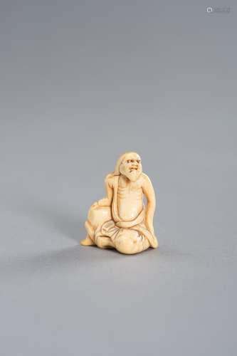 AN IVORY NETSUKE OF A SENNIN