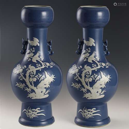 A pair of white binaural bottles with blue background in the...