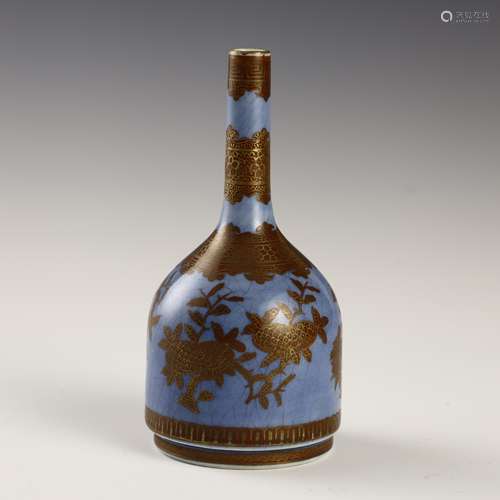 Gold pomegranate bottle with blue sky and ground