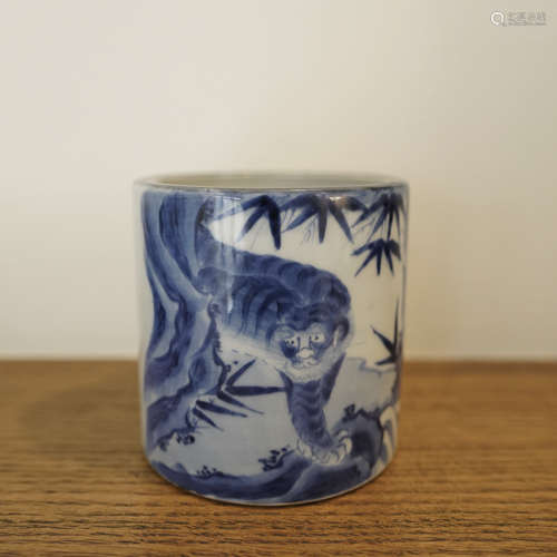 A CHINESE BLUE AND WHITE TIGER AND BAMBOO BRUSH POT