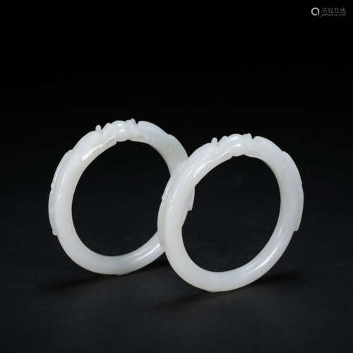 A PAIR OF CHINESE HETIAN WHITE JADE DRAGON BRACELETS, QING D...