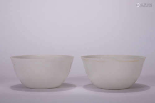 A pair of white glazed cup