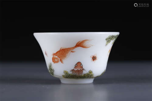 A Glass Cup with Fish and Algae Design.