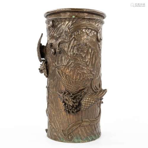 A brush pot made of bronze and decorated with mythological f...