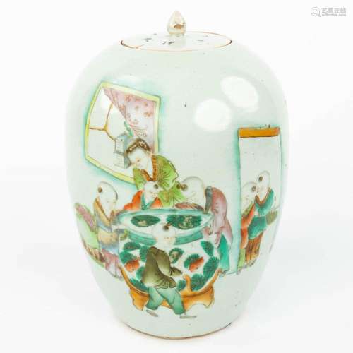 A Chinese jar with lid and decorated with children looking i...