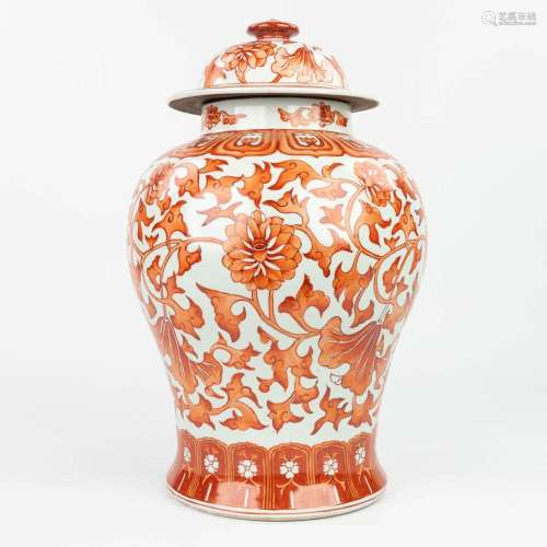 A Chinese vase made of porcelain and decorated with red flor...