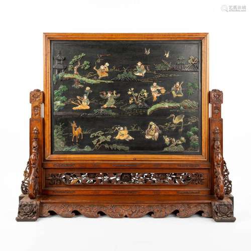 A Chinese sculptured table screen with images of the 8 immor...