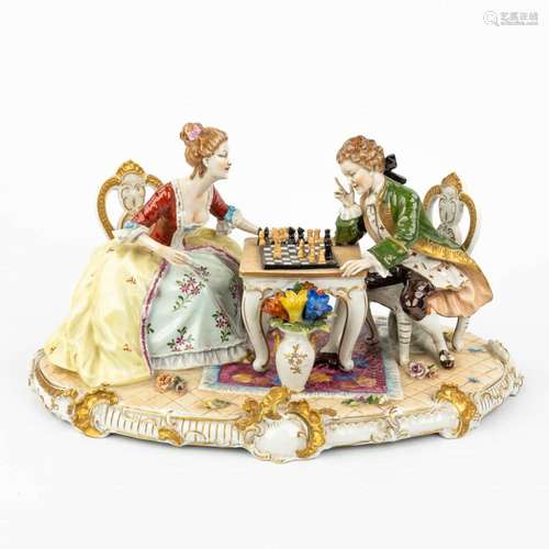 A large porcelain group of a chess-playing couple marked O. ...