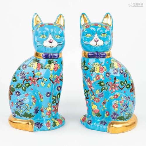 A pair of decorative cats made of glazed faience in the styl...