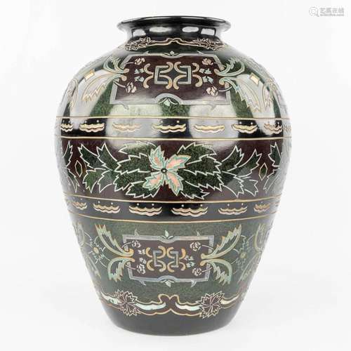 A decorative vase made of glazed porcelain with relief decor...