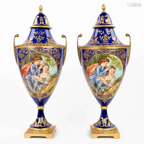 A pair of vases with a hand-painted decor in sèvres style. M...