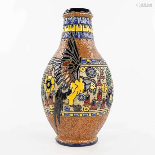 A vase made of glazed faience and decorated with an ara parr...