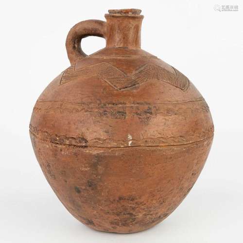 An antique jug with the original stopper made of terracotta ...