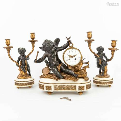 A three-piece mantle clock decorated with putti and a satyr,...