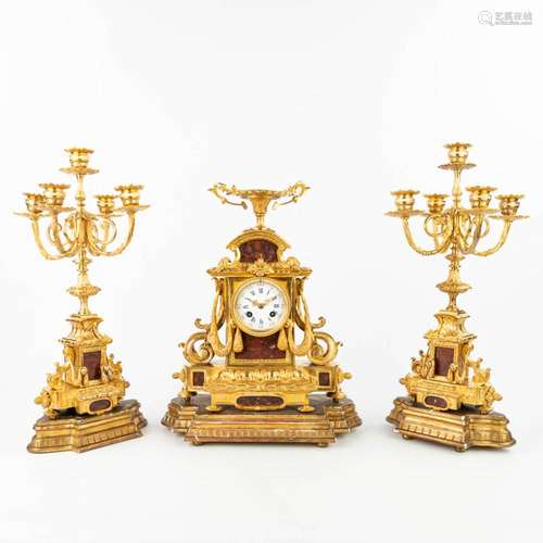 A three-piece garniture clock, inlaid with red marble and st...