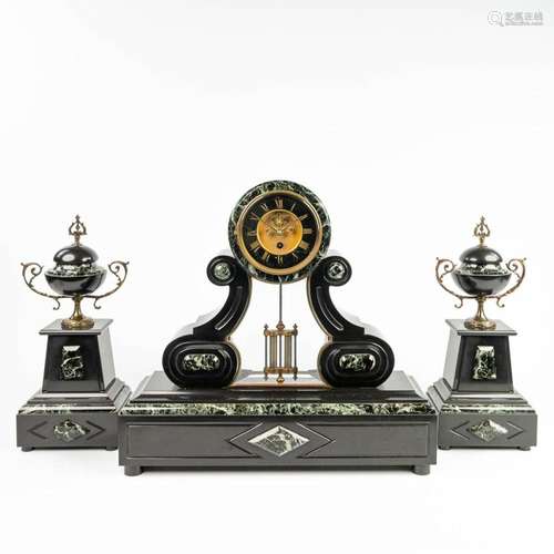 A three-piece mantle garniture clock made of black marble. (...