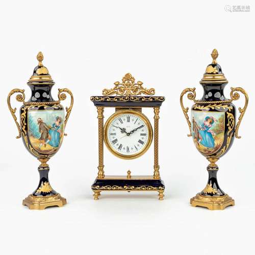 A three-piece mantle garniture with clock and side pieces ma...