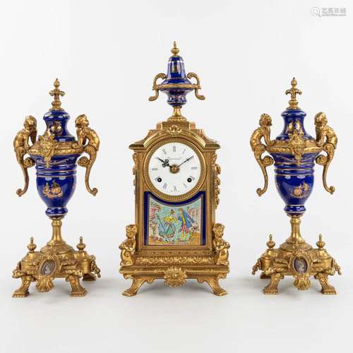 A three-piece mantle garniture clock made of bronze and porc...