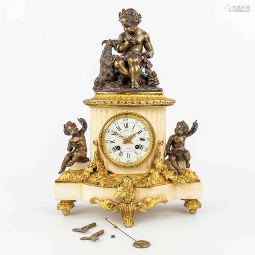 A clock made of marble and decorated with gilt and patinated...