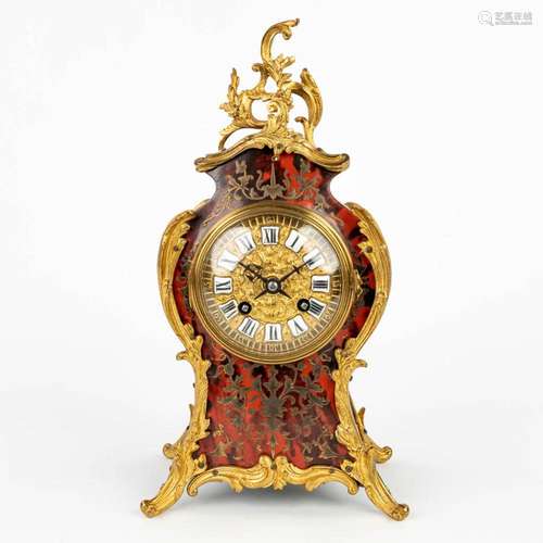 A mantle clock decorated with boulle inlay and mounted with ...