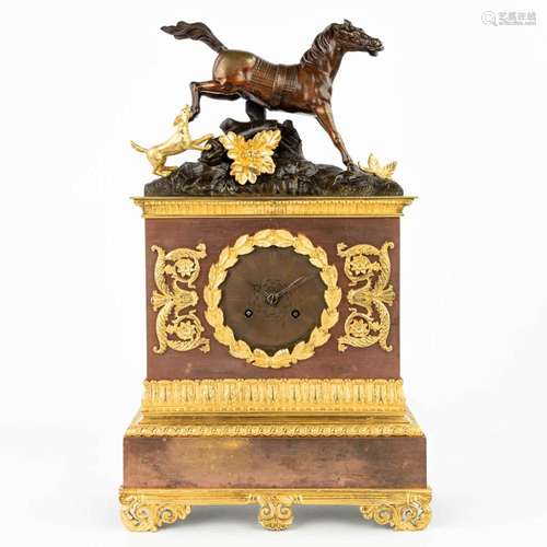 A mantle clock made of bronze and decorated with a horse and...