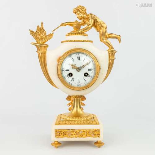 A mantle clock made of white Carrara marble mounted with gil...