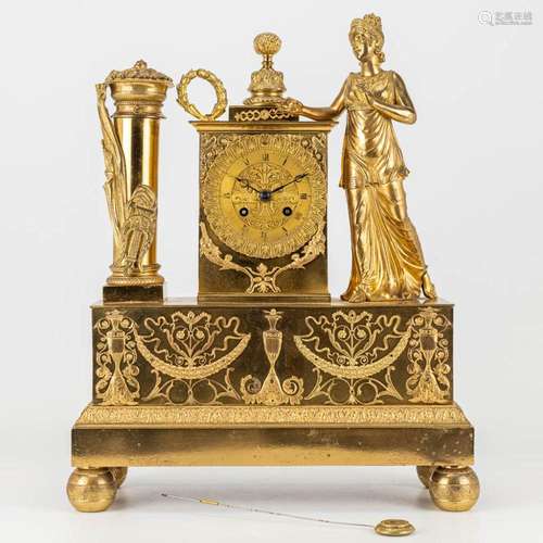 A mantle clock made of gilt bronze in empire style. The firs...