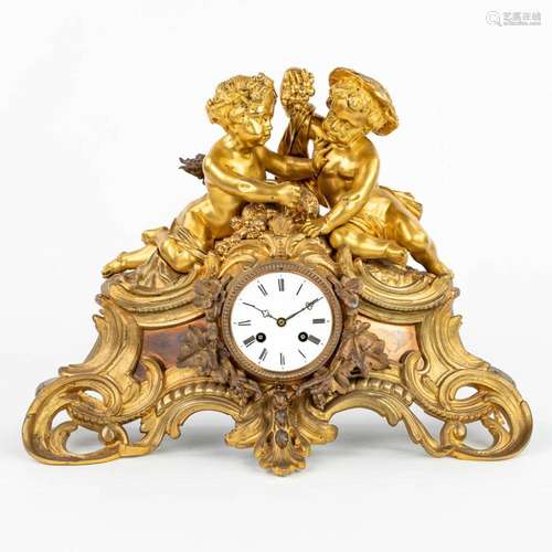 A mantle clock made of gilt bronze and decorated with putti ...