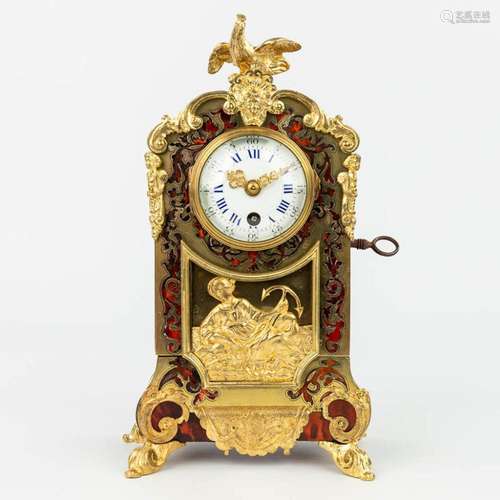 A mantle clock finished with tortoise shell Boulle inlay and...