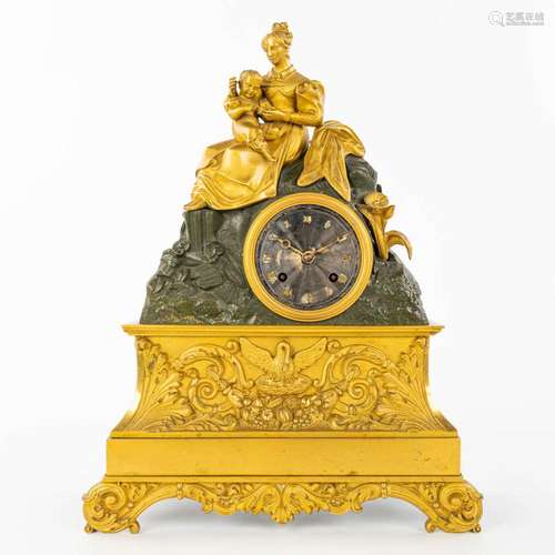 A table clock made of gilt and patinated bronze in empire st...