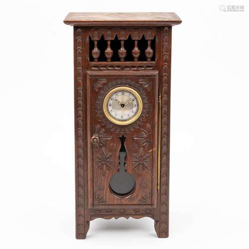 A table clock mounted in a miniature Breton cabinet. (H:35,5...