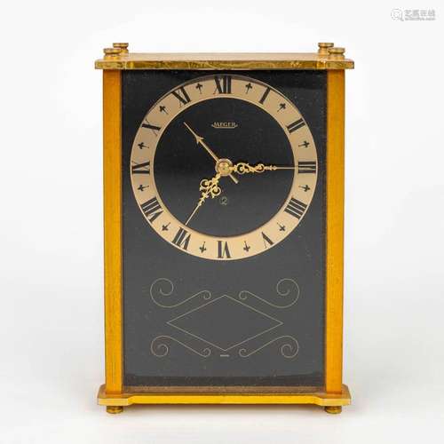 A table alarm clock, marked Jaeger. Made in Switzerland. (H:...