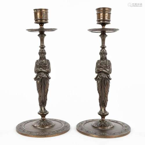 A pair of caryatid candlesticks, Empire style, patinated bro...