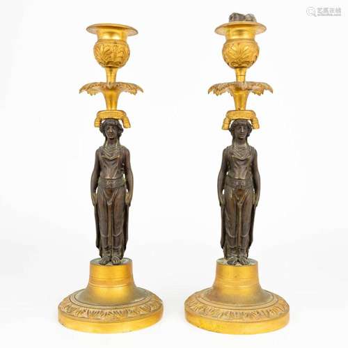 A pair of caryatid candlesticks, made of patinated and ormol...