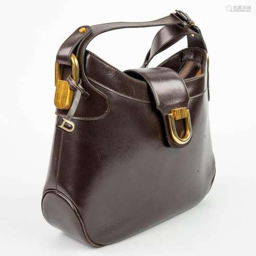 A purse made of brown leather and marked Delvaux. Mounted wi...