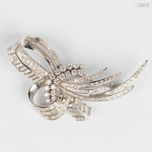 A brooch made of white gold and decorated with approximately...