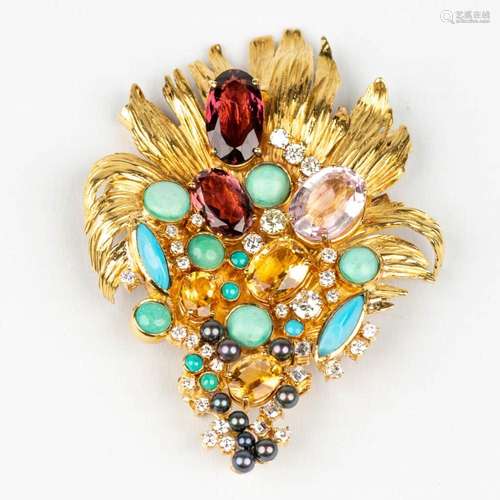 A large brooch decorated with multiple different precious st...