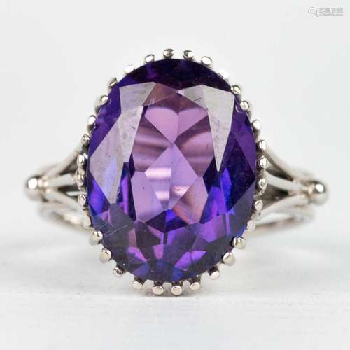 A ring with purple natural stone, made of 18 karat white gol...