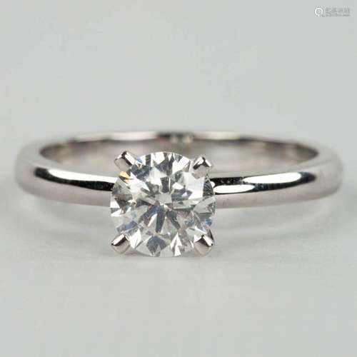 An engagement ring with a solitaire stone in a white gold ri...