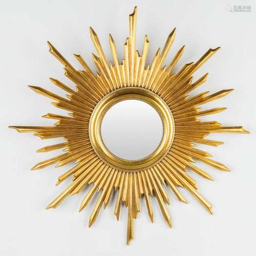 A large sunburst mirror made of sculptured wood, 20th centur...