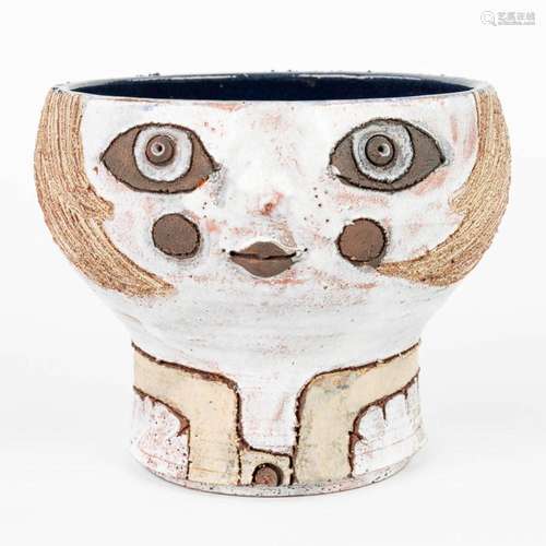 A vase in the shape of a face, made of glazed ceramics for P...