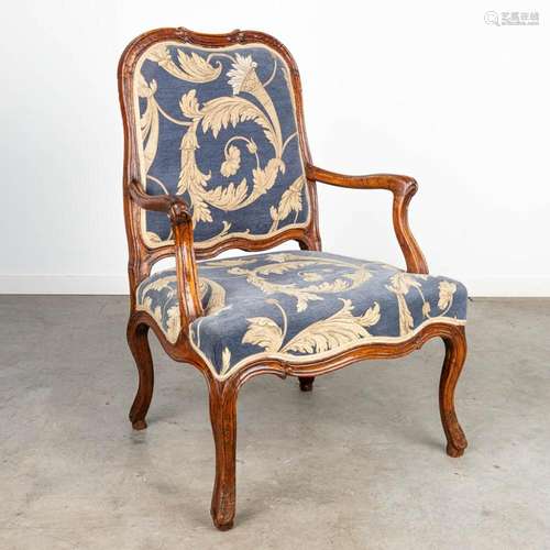 An armchair made in a Louis XV style and upholstered with fa...