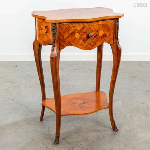 A side table finished with marquetry inlay and mounted with ...