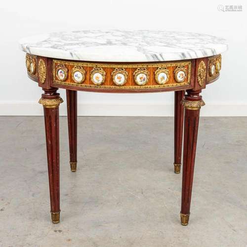 A coffee table with marble top and plaques made of porcelain...