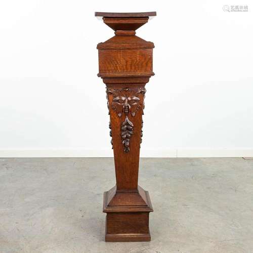 A pedestal made of sculptured wood and finished with mytholo...