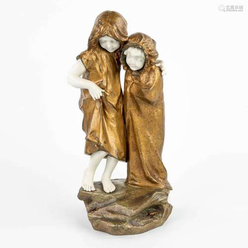 A statue of 2 children with a lobster and crab, made of spel...