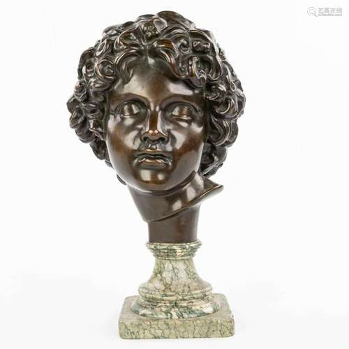 A bronze head of a young man, mounted on a marble base. Mark...