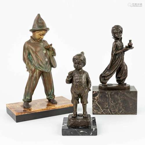 A collection of 3 statues of boys made of bronze and spelter...